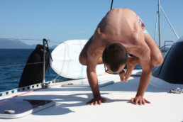 Yoga on deck of catamaran Pluto